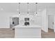 Bright kitchen boasts modern appliances, a quartz island, and stylish pendant lighting at 13584 Sw 43Rd Cir, Ocala, FL 34473