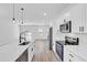 Open kitchen boasts stainless steel appliances, white cabinets, and a quartz countertop at 13584 Sw 43Rd Cir, Ocala, FL 34473