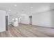 Bright, open-concept living space featuring modern gray wood floors and recessed lighting at 13584 Sw 43Rd Cir, Ocala, FL 34473