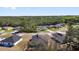 Picturesque aerial scene showcasing a community of homes set against a backdrop of lush green trees at 13594 Sw 40 Cir, Ocala, FL 34473