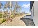 View of the backyard showing wooded space and small patio at 13594 Sw 40 Cir, Ocala, FL 34473