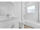 Bathroom featuring tiled shower-tub and vanity with quartz counters at 13594 Sw 40 Cir, Ocala, FL 34473