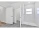 Bright bathroom features a spacious shower with white tiled walls and gray tile flooring at 13594 Sw 40 Cir, Ocala, FL 34473