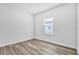 Bright bedroom featuring wood-look flooring, window, and neutral walls at 13594 Sw 40 Cir, Ocala, FL 34473