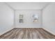 Neutral bedroom design with wood floors and large windows providing natural light at 13594 Sw 40 Cir, Ocala, FL 34473