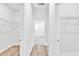 Hallway featuring wood-look flooring leading to rooms at 13594 Sw 40 Cir, Ocala, FL 34473