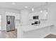 Bright and modern kitchen with stainless steel appliances, white cabinets and a breakfast bar at 13594 Sw 40 Cir, Ocala, FL 34473
