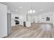 Modern kitchen with stainless steel appliances, white cabinetry, and stylish hardwood floors at 13594 Sw 40 Cir, Ocala, FL 34473