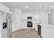 Contemporary kitchen features stainless appliances, white cabinets and a quartz countertop with pendant lights at 13594 Sw 40 Cir, Ocala, FL 34473