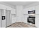 Bright kitchen features stainless steel appliances, white cabinetry, and modern finishes at 13594 Sw 40 Cir, Ocala, FL 34473