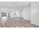Open-concept living area with hardwood floors, bright white walls and natural light from the sliding glass door at 13594 Sw 40 Cir, Ocala, FL 34473