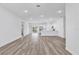 Spacious open-concept living area with hardwood floors, white walls, and access to the kitchen at 13594 Sw 40 Cir, Ocala, FL 34473