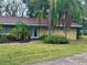 Charming single-story home with well-maintained lawn and mature trees, creating a welcoming curb appeal at 1361 Markham Woods Rd, Longwood, FL 32779