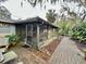 Cozy screened porch with brick pavers and tranquil views of lush landscaping creates a relaxing outdoor living space at 1361 Markham Woods Rd, Longwood, FL 32779