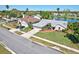 Aerial view showcases a well-maintained home and lawn situated by a lake at 14772 Eagles Crossing Dr, Orlando, FL 32837