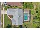 Aerial view of a home with a screened-in pool, manicured lawn, and mature landscaping at 14772 Eagles Crossing Dr, Orlando, FL 32837