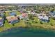 Aerial view of homes with screened-in pools, lush lawns, and waterfront access at 14772 Eagles Crossing Dr, Orlando, FL 32837