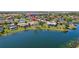 Aerial view of homes with screened-in pools, lush lawns, and waterfront access at 14772 Eagles Crossing Dr, Orlando, FL 32837