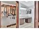 This split image shows a walk-in closet and a bathroom with double sinks at 14772 Eagles Crossing Dr, Orlando, FL 32837