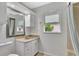 Bright bathroom with granite vanity, framed mirror, and shower-tub combo at 14772 Eagles Crossing Dr, Orlando, FL 32837