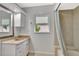 Bright bathroom with granite vanity, framed mirror, and shower-tub combo at 14772 Eagles Crossing Dr, Orlando, FL 32837