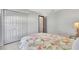 Bedroom features a closet with double doors and an ornate bedside lamp at 14772 Eagles Crossing Dr, Orlando, FL 32837