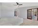 This bedroom has wood-look flooring and glass doors leading to a sunroom at 14772 Eagles Crossing Dr, Orlando, FL 32837