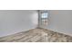 Bedroom with a window that lets in natural light and wood-look floors at 14772 Eagles Crossing Dr, Orlando, FL 32837