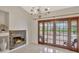 Bright dining area with stone fireplace and large sliding glass doors leading to the pool at 14772 Eagles Crossing Dr, Orlando, FL 32837