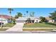 Charming single-story home featuring a two-car garage, a well-manicured lawn, and mature trees at 14772 Eagles Crossing Dr, Orlando, FL 32837