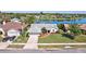 Well-maintained single-story home boasts a lush green lawn, landscaping, and a waterfront view at 14772 Eagles Crossing Dr, Orlando, FL 32837