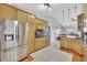 Open kitchen featuring stainless refrigerator, custom cabinets, and granite counters at 14772 Eagles Crossing Dr, Orlando, FL 32837
