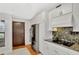 Bright kitchen features stainless steel appliances, granite countertops and white cabinets at 14772 Eagles Crossing Dr, Orlando, FL 32837