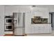 Well-lit kitchen features stainless steel appliances and matching cabinetry for a modern, clean design at 14772 Eagles Crossing Dr, Orlando, FL 32837