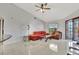 Cozy living room with tile floors, vaulted ceiling, and access to outdoor space at 14772 Eagles Crossing Dr, Orlando, FL 32837