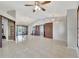 Open-concept living room featuring tile flooring, chandelier lighting, and access to outdoor spaces and bedrooms at 14772 Eagles Crossing Dr, Orlando, FL 32837