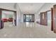 Spacious living room with tile floors, chandelier lighting, and doors leading to the outdoor space at 14772 Eagles Crossing Dr, Orlando, FL 32837