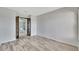 Living room with wood look flooring, gray walls, and glass paneled doors at 14772 Eagles Crossing Dr, Orlando, FL 32837