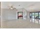 Expansive living room with modern tile flooring, featuring a chandelier and fireplace at 14772 Eagles Crossing Dr, Orlando, FL 32837