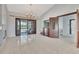 Open floor plan with tile, chandelier lighting and sliding glass doors that lead to outdoor pool at 14772 Eagles Crossing Dr, Orlando, FL 32837