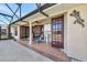 Covered patio with seating and access to an outdoor sink with views of a pool and yard at 14772 Eagles Crossing Dr, Orlando, FL 32837