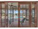 View of a screened-in patio and swimming pool through glass doors at 14772 Eagles Crossing Dr, Orlando, FL 32837