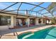 Backyard pool with a screened-in patio and outdoor seating at 14772 Eagles Crossing Dr, Orlando, FL 32837