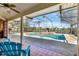 The screened-in patio features a swimming pool overlooking a peaceful lake at 14772 Eagles Crossing Dr, Orlando, FL 32837