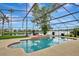 Screened-in pool overlooks large body of water and well-manicured lawn at 14772 Eagles Crossing Dr, Orlando, FL 32837