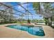 Lovely screened-in pool with lake views and a spacious concrete deck at 14772 Eagles Crossing Dr, Orlando, FL 32837
