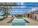 Inviting screened-in pool and spa with lake views, perfect for relaxing or entertaining at 14772 Eagles Crossing Dr, Orlando, FL 32837