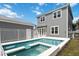 Backyard features a pool, spa, white fence, and detached garage at 1552 Fairview Cir, Reunion, FL 34747