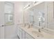Bright bathroom featuring double vanity, large mirror, and bedroom view at 1552 Fairview Cir, Reunion, FL 34747