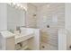 Modern bathroom featuring a spacious sink and a beautifully tiled shower, designed for relaxation and comfort at 1552 Fairview Cir, Reunion, FL 34747